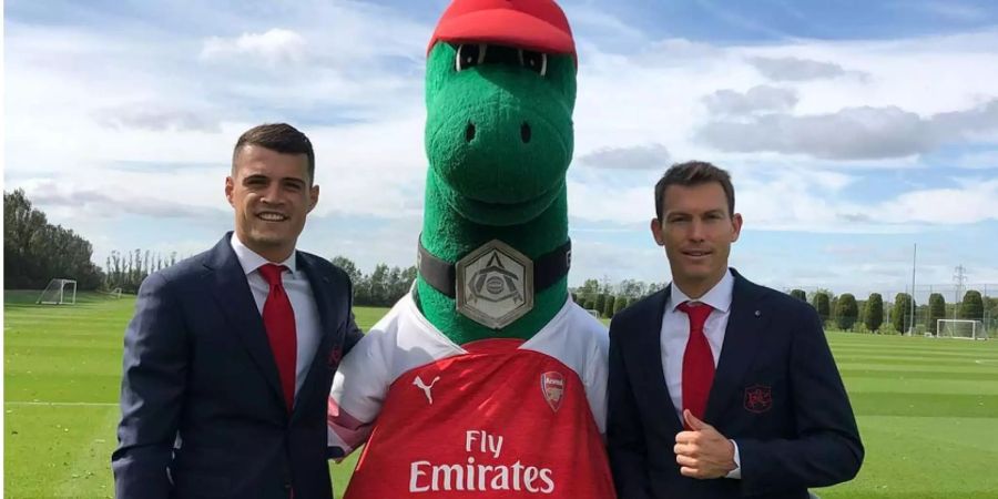 Granit Xhaka und Stephan Lichtsteiner posieren mit dem Gunnersaurus, dem Maskottchen des FC Arsenal.