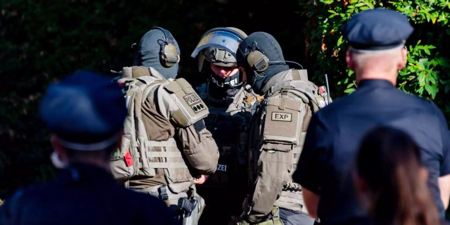 Mitglieder einer Spezialeinheit der Polizei stehen in Hamburg vor der Wohnung.