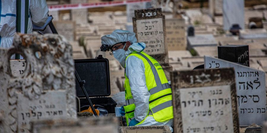 Gerichtsmediziner arbeiten an einem Grab auf dem Friedhof von Petach Tikva in Tel Aviv.
