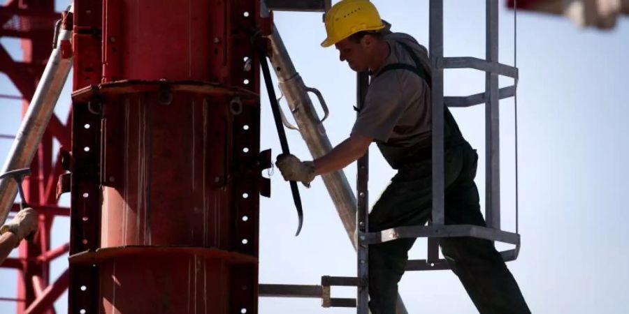 Ein Mann arbeitet auf einer Baustelle. Der Frühjahrsaufschwung hat die Arbeitslosenzahlen im April nach Einschätzung von Experten sinken lassen. Foto: Alexander Heinl