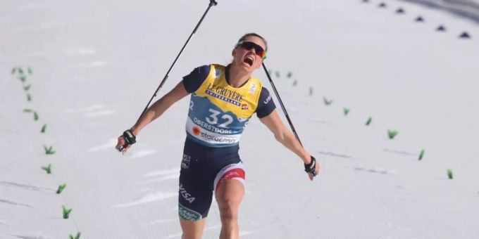 Jessie Diggins aus den USA fährt in kurzen Hosen ins Ziel. Jessie Diggins