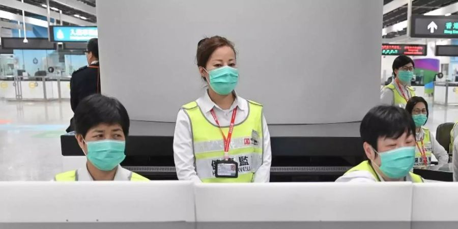 Vorsorge in Hongkong: Mitarbeiter des Gesundheitswesens untersuchen am Bahnhof West Kowloon Station Reisende auf ihren Gesundheitszustand. Foto: Informationsdienst der Hongkonger Regierung/AP/dpa