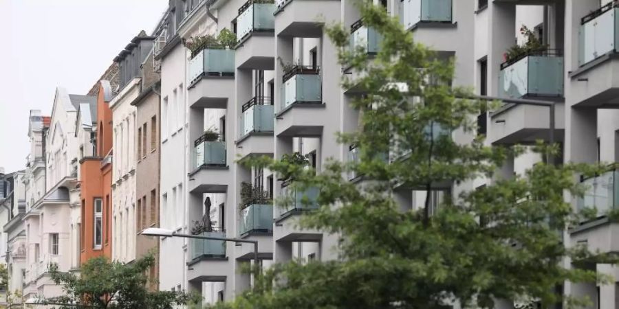 Neu gebaute Häuser mit Eigentumswohnungen (r) stehen neben Altbauten in Köln. Foto: Oliver Berg/dpa