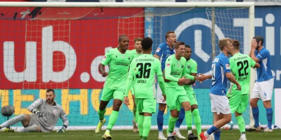 Die Spieler von SV Sandhausen bejubeln das Tor zum 1:0 bei Hansa Rostock. Foto: Danny Gohlke/dpa
