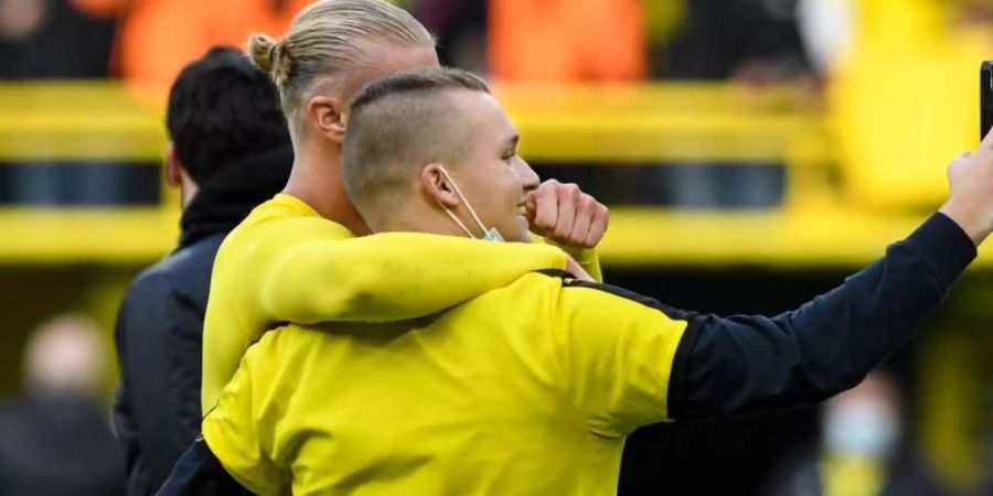 Erst Matchwinner, dann mit Fannähe: Dortmunds Stürmer Erling Haaland macht nach dem Sieg gegen Mainz ein Selfie mit einem Fan. Foto: Bernd Thissen/dpa