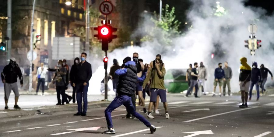 Protesters storm Parliament in Belgrade after new coronavirus restrictions imposed