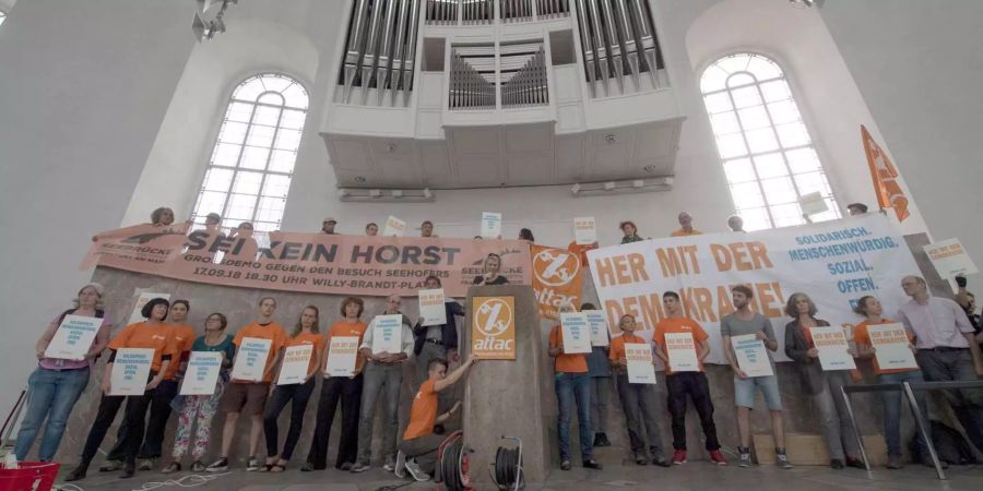 Attac-Aktivisten stehen in der Paulskirche und besetzen den Gedenkort als symbolischen Protest.