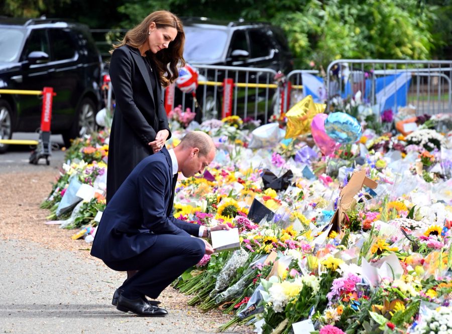 Prinz William und Kate schauen sich die Blumen für die Queen an.