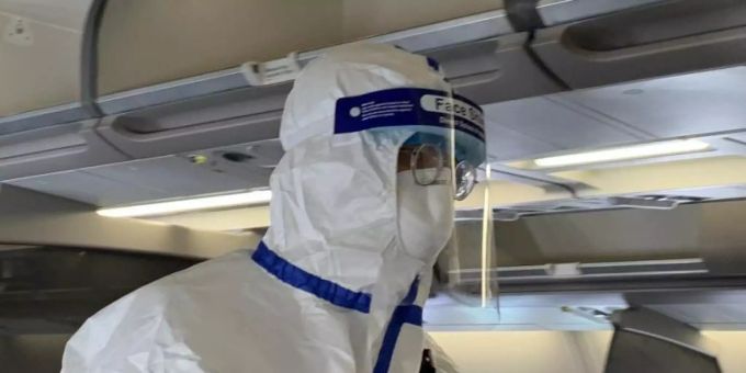 Ein Beamter der chinesischen Gesundheitsbehörde begleitet den Sonderflug, um die Körpertemperatur von Passagieren zu messen und nach Krankheitssymptomen zu fragen. Foto: Andreas Landwehr/dpa Ein Beamter der chinesischen Gesundheitsbehörde begleitet den Sonderflug, um die Körpertemperatur von Passagieren zu messen und nach Krankheitssymptomen zu fragen. Foto: Andreas Landwehr/dpa