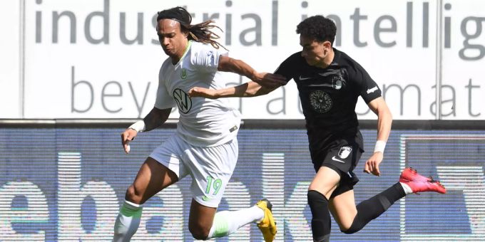 Kevin Mbabu (l.) vom VfL Wolfsburg im Duell mit Augsburgs Ruben Vargas. Kevin Mbabu Erlösung