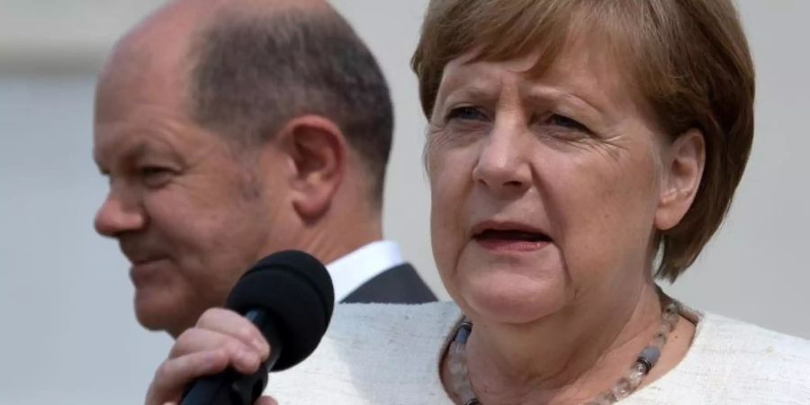 Vizekanzler Olaf Scholz (SPD) hinter Angela Merkel (CDU). Die Kanzlerin bleibt laut Umfrage das beliebteste Regierungsmitglied. Foto: Ralf Hirschberger