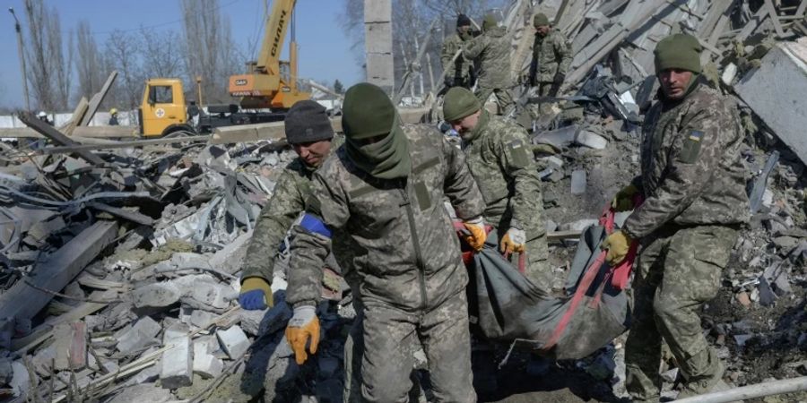 Soldaten bergen eine Leiche aus der Kaserne in Mykolajiw
