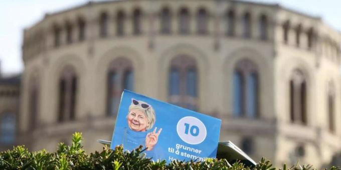 Ein Flyer der norwegischen Regiergungschefin Erna Solberg steckt vor dem Parlament in Oslo in einer Hecke. Bewahrheiten sich die Umfragen, dann ist die Regierungszeit der konservativen Ministerpräsidentin nach acht Jahren zu Ende. norwegen