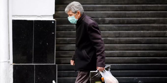 Ein Mann mit Mundschutz geht an einem geschlossenen Geschäft in Algier vorbei. Coronavirus - Algerien