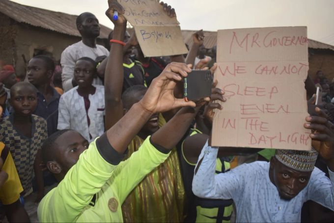 Menschen versammeln sich dort, wo Bewaffnete die Schulkinder entführt haben. nigeria entführung schüler kinder