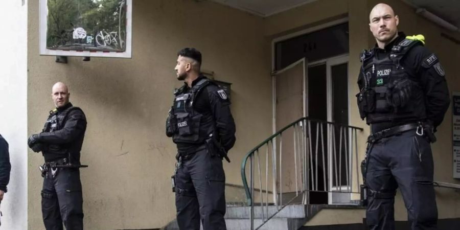 Polizeibeamte stehen im Rahmen einer Razzia auf der Mecklenburgischen Strasse in Berlin. Foto: Paul Zinken/dpa-zb-Zentralbild/dpa