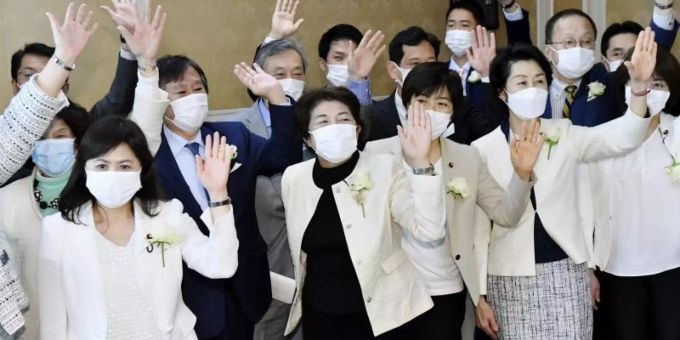 Weibliche Abgeordnete der Opposition tragen weisse Jacken mit weissen Rosen als Protest gegen sexistische Äusserungen von OK-Chef Mori. Foto: //kyodo/dpa Weibliche Abgeordnete der Opposition tragen weisse Jacken mit weissen Rosen als Protest gegen sexistische Äusserungen von OK-Chef Mori. Foto: //kyodo/dpa