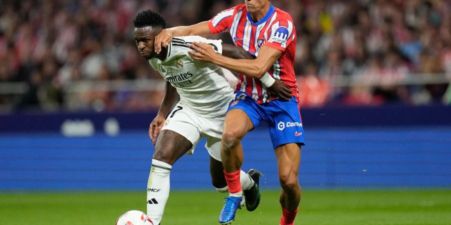 Kämpfen um den Ball und den Sieg im Stadtderby von Madrid: Reals Vinicius Junior (l) und Atleticos Marcos Llorente