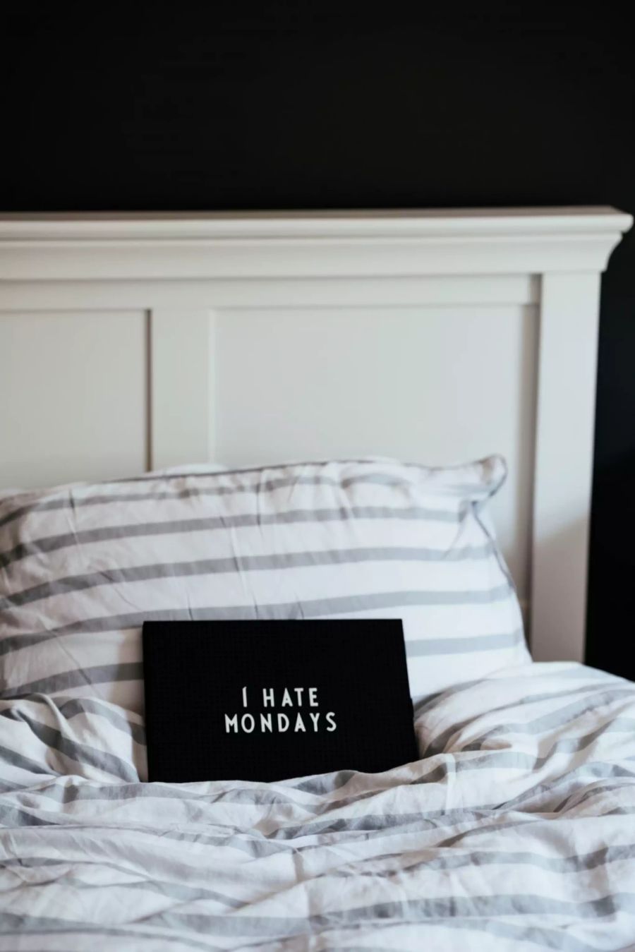 Schild auf Bett "I hate Mondays".