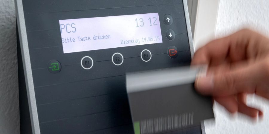 Digitale Arbeitszeiterfassung an einem Terminal (Symbolbild). Atypische Arbeitszeiten wie Schicht- oder Wochenendarbeit führen laut Arbeitszeitbericht häufig zu weniger Zufriedenheit mit der sogenannten Work-Life-Balance.