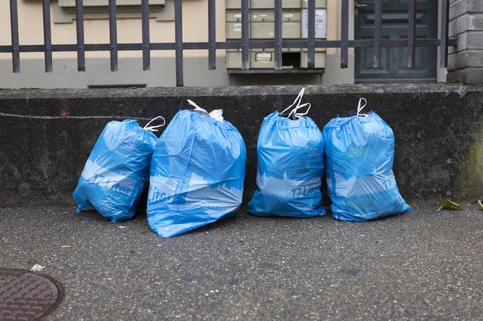Blaue Gebührensäcke mit Hauskehricht auf einem Trottoir in Bern. Linke Stadtparlamentarier sehen den Ursprung des Problems der überquellenden Entsorgungsstellen in der Kommunikation. (Symbolbild) Müllentsorgung Bern