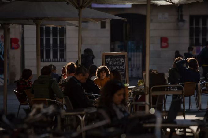23.11.2020, Spanien, Barcelona: Menschen sitzen auf der Terrasse eines Cafés in Barcelona. Nach fünfwöchiger Zwangsschliessung zur Eindämmung der Corona-Pandemie ist das öffentliche Leben in Katalonien mit der Touristenmetropole Barcelona ab Montag vorsichtig wieder hochgefahren worden. Foto: David Zorrakino/EUROPA PRESS/dpa +++ dpa-Bildfunk +++ Coronavirus - Spanien