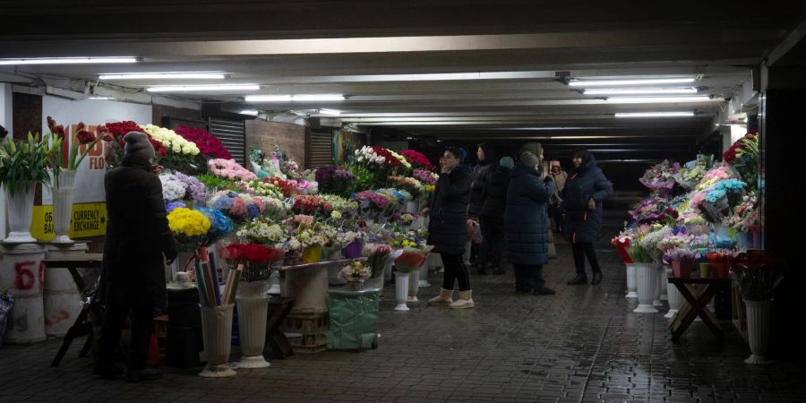 Blumenverkäufer unterhalten sich in einem unterirdischen Durchgang im Stadtzentrum von Kiew.
