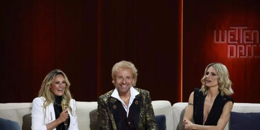 Thomas Gottschalk eingerahmt von Helene Fischer (l) und Michelle Hunziker (r). Vor 40 Jahren wurde die Sendung zum ersten Mal ausgestrahlt. Foto: Daniel Karmann/dpa