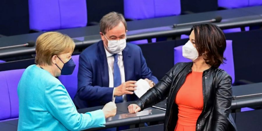 Angela Merkel, Armin Laschet und Annalena Baerbock