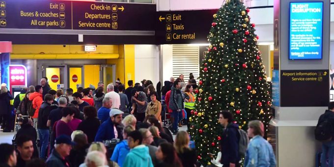 Passagiere warten in einer Schlange am Flughafen London-Gatwick auf Informationen. Passagiere warten in einer Schlange am Flughafen London-Gatwick auf In