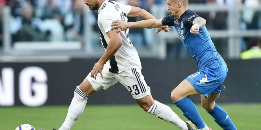 Juves Emre Can (l) behauptet gegen Empolis Rade Krunic den Ball. Foto: Alessandro Di Marco/ANSA/AP/dpa
