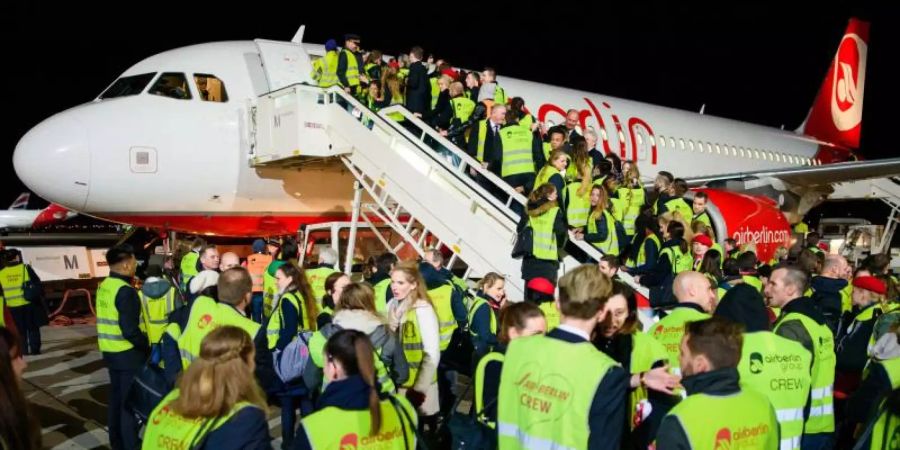 Air-Berlin-Mitarbeiter nach der Landung der letzten Maschine auf dem Flughafen Berlin-Tegel. Foto: Gregor Fischer/dpa