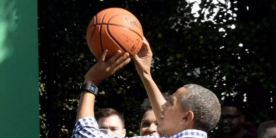Barack Obama wirft beim White House Easter Egg Roll 2015 einen BasketBall auf den Korb. Foto: Olivier Douliery / Pool/SIPA POOL/dpa