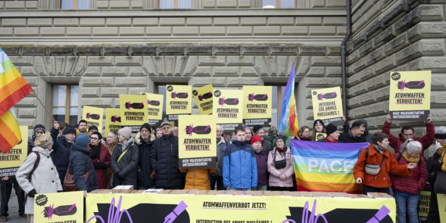 Mit Friedensfahnen und Transparenten ausgerüstet, reichte die Allianz für ein Atomwaffenverbot am Dienstag 135'000 Unterschriften für eine Volksinitiative bei der Bundeskanzlei ein.
