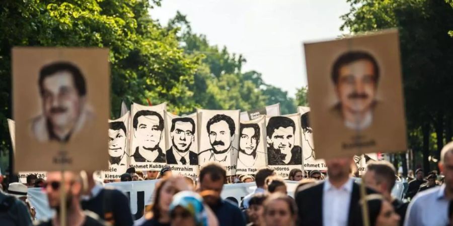 Demonstranten während einer Kundgebung mit Porträt-Abbildungen der NSU-Opfer im August 2018 in München. Foto: Lino Mirgeler/dpa/Archiv