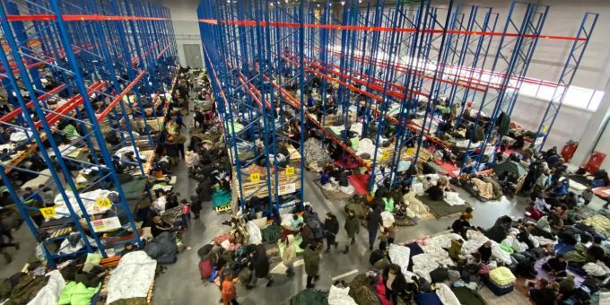 19.11.2021, Belarus, Brusgi: Migranten sind in der Notunterkunft in der Lagerhalle eines Logistikzentrums nahe der Grenze zu Polen untergebracht. Lage an der polnisch-belarussischen Grenze