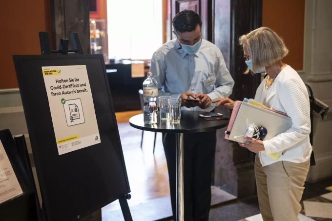Nationalrätin Prisca Birrer-Heimo, SP-LU, rechts, zeigt dem Security-Mitarbeiter Arber Sulejmani ihr Covid Zertifikat, um ins Cafe Vallotton zu gelangen, an der Herbstsession der Eidgenössischen Räte, am Montag, 13. September 2021 im Nationalrat in Bern. CORONAVIRUS, CORONA-VIRUS, COVID-19,