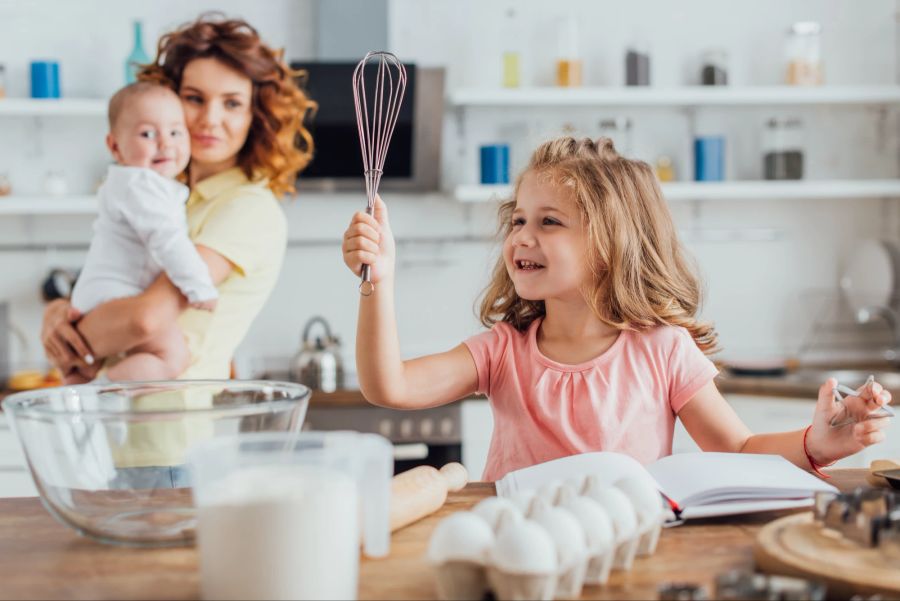 Mutter mit Kindern in der Küche, gemeinsames Kochen und Backen