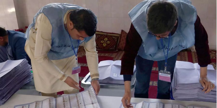 Mitarbeiter der Afghanischen Unabhängigen Wahlkommission (IEC) zählen die Stimmzettel aus.