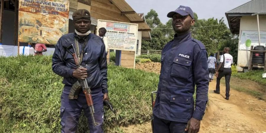 Kongolesische Polizisten bewachen ein Gesundheitszentrum, in dem Ebola-Impfungen stattfinden (Archiv). Foto: Al-Hadji Kudra Maliro/AP