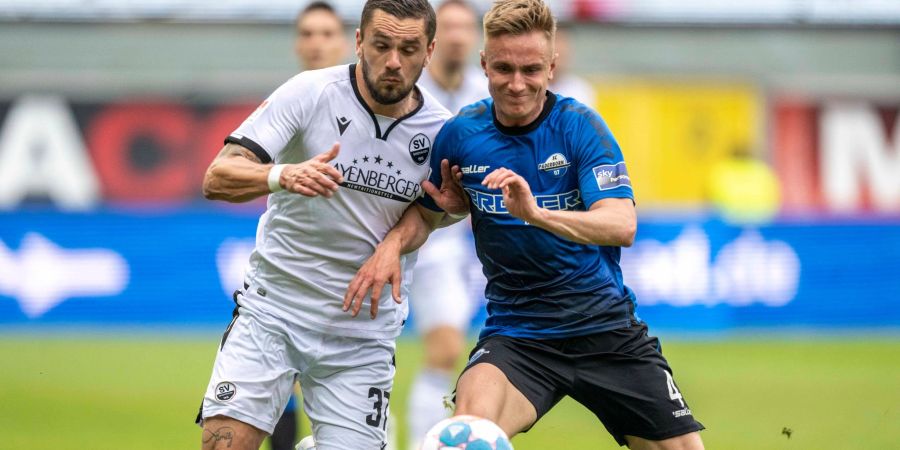 Pascal Testroet (l) vom SV Sandhausen und Paderborns Jasper van der Werff im Zweikampf.