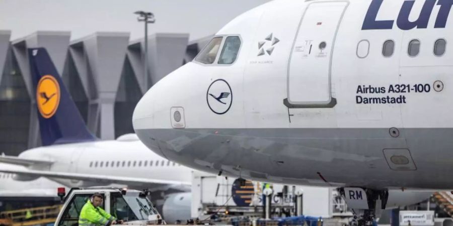 Ein Diesel-Schlepper zieht einen Airbus der Lufthansa von seiner Position am Fluggaststeig in Frankfurt. Foto: Frank Rumpenhorst/dpa