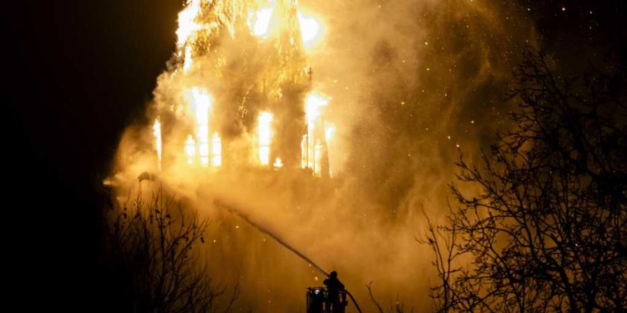 Einsatzkräfte der Feuerwehr löschen die brennende Vondelkirche in der Nähe des Vondelparks. Foto: REMKO DE WAAL/ANP/dpa