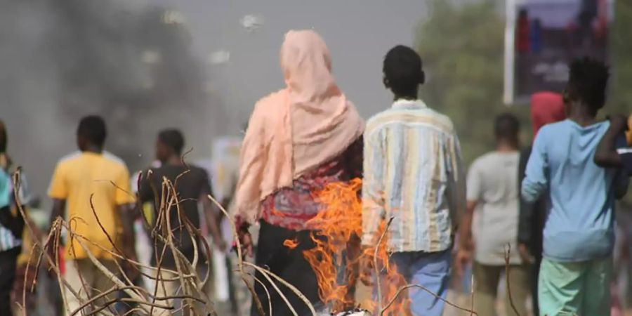 dpatopbilder - Pro-demokratische Demonstranten blockieren mit Feuer die Strassen, um die Machtübernahme durch das Militär zu verurteilen. Foto: Ashraf Idris/AP/dpa