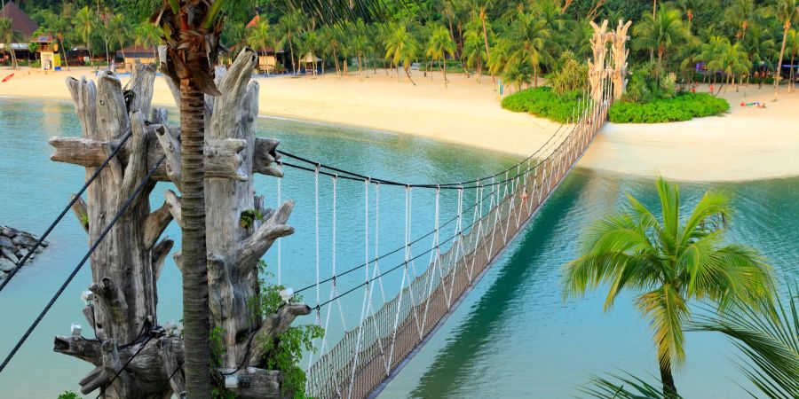 Freizeit Park am Meer mit Brücke und Sandstrand in Sentosa, Singapur.