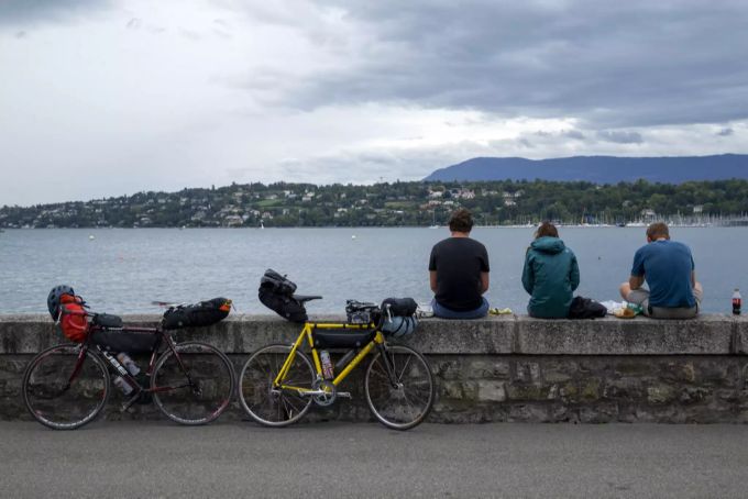 Am Genfersee gönnen sich drei Velofahrer mit geringem Abstand eine Pause. Abstand Regeln