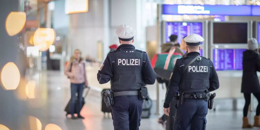 Bundespolizisten gehen durch den Frankfurter Flughafen.