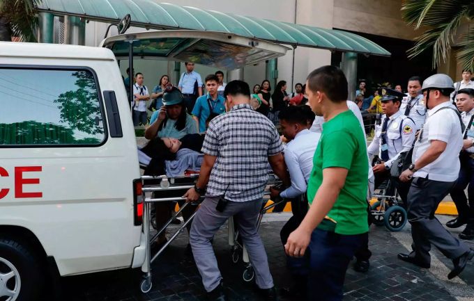Rettungskräfte tragen am 22.04.19 eine Frau in Manila zu einem Krankenwagen, nachdem ihr nach dem Beben schwindlig wurde. Erdbeben Philippinen