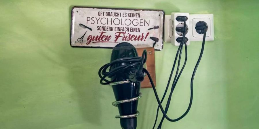 Ein Föhn in einem geschlossenen Friseursalon im Frankfurter Nordend. Foto: Frank Rumpenhorst/dpa