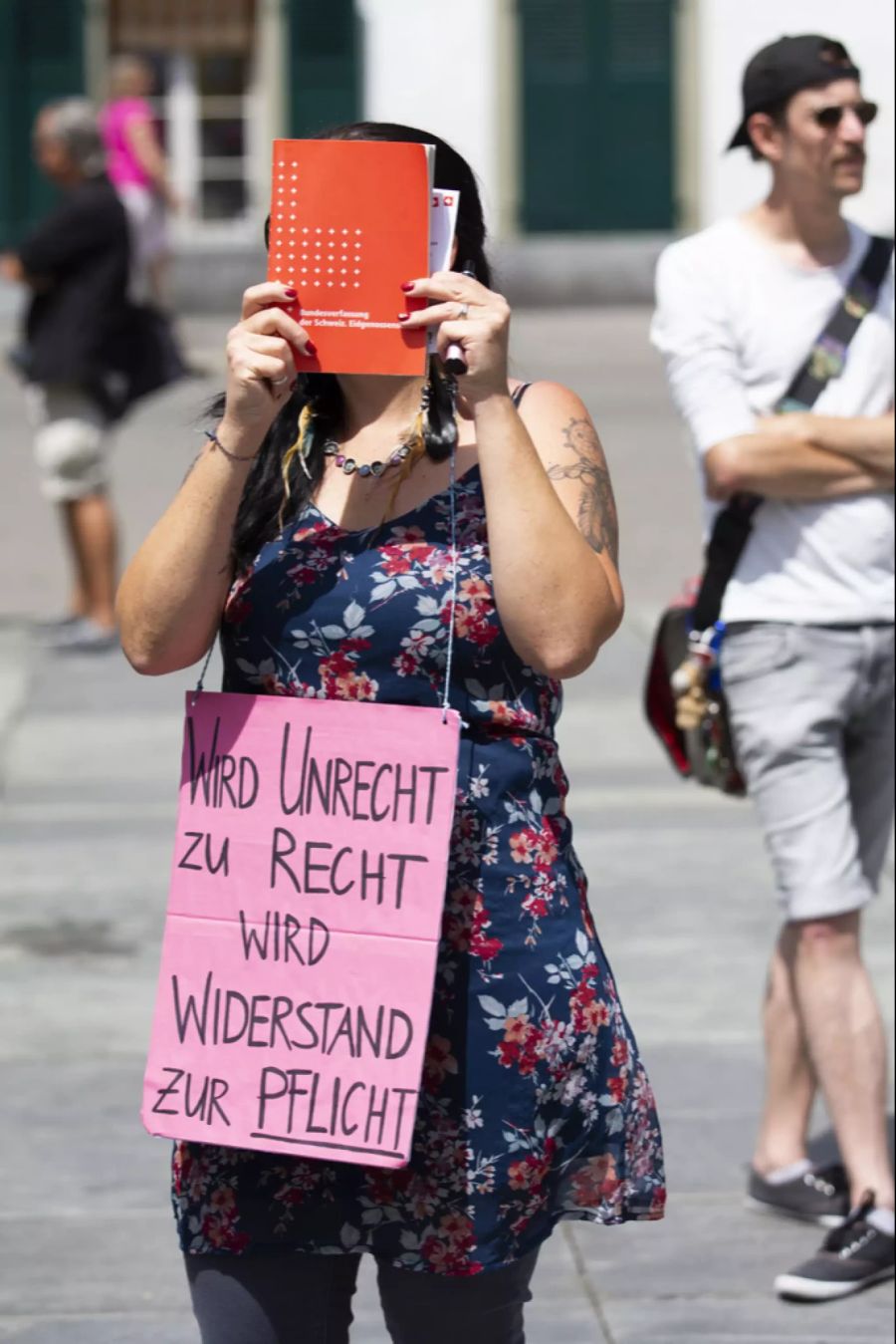 Eine Demonstrantin hält sich ein Exemplar der Schweizer Bundesverfassung vor das Gesicht bei einer Demonstration gegen die Massnahmen des Bundesrates im Zusammenhang mit dem Coronavirus, am